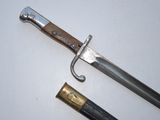 a knife that is laying on a table next to a pen