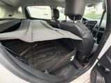 the interior of a car with a seat folded down and a car floor mat