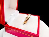 a wedding ring in a red box on a white plate