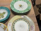 many plates and bowls sitting on a table with a box in the background