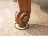 a close up of a wooden object on a marble floor