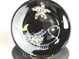a black and white plate with a fish design on it