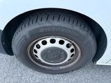 a close up of a tire on a white car
