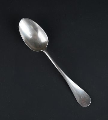 a spoon that is sitting on a black surface