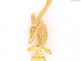 a gold colored brooch with a bird on top of it
