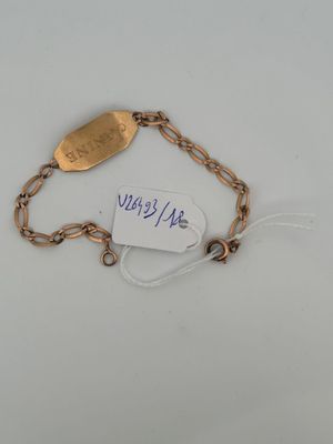 a close up of a gold bracelet with a tag on it