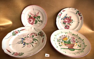 three plates with floral designs are sitting on a gold cloth