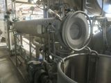 a machine that is inside of a building with pipes and valves