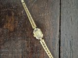 a watch that is laying on a wooden table