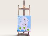 un petit chevalet sur lequel est posé un tableau représentant un chat