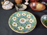 many bowls and bowls on a table with a black background