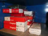 many boxes of pizza sitting on a shelf in the kitchen