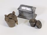 a small silver box with a lid next to a smaller silver container