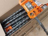 a box of drill bits sitting on the floor next to a pair of scissors