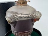 a vase with a bird on top of it in a box