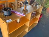 a wooden table with a pot on it in a room