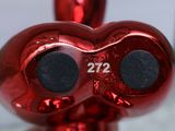 a red heart shaped object with a number on it