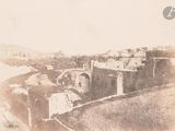 an old photo of a castle in the middle of a field