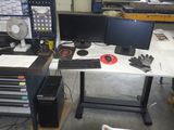 a desk with two monitors and a keyboard on it
