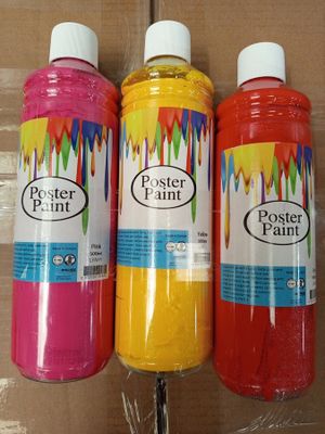 three bottles of paint are sitting on a cardboard box