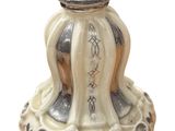 a white vase with a silver lid sitting on a table