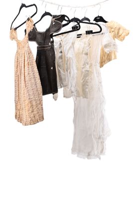 three dresses hanging on a clothes rack on a white background