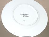a white plate with a black writing on it sitting on a table