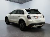 the rear view of a white fiat suv parked in a garage
