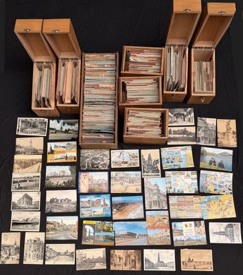 a large collection of old postcards and postcards on a table