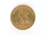 a gold coin with a bird on it on a white surface