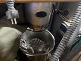 a machine that is sitting on the floor next to a bucket