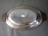 a silver plate with a wooden handle on a table