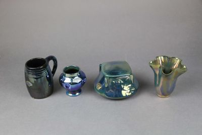 three vases and a pitcher sitting next to each other on a table