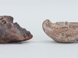 two pieces of pottery sitting next to each other on a table