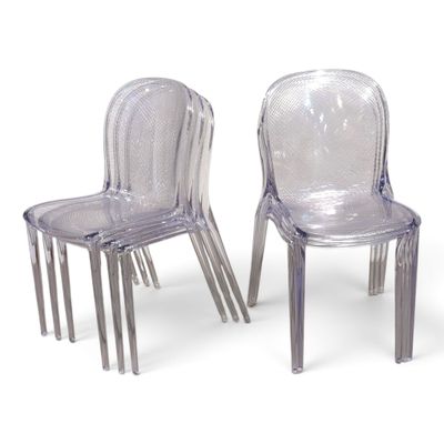 pair of clear plastic chairs sitting next to each other on a white surface