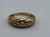 an image of a gold ring on a white surface