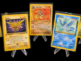 pokemon cards are lined up in a row on a black background