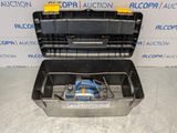 an open tool box with a tool in it sitting on a table