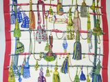 a picture of a red and white scarf with a lot of tassels on it
