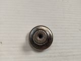 a metal button that is on a white surface
