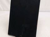 an ipad is sitting on a stand on a white surface