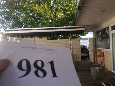 a person holding a piece of paper in front of a house