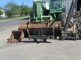 a tractor that is parked in front of a building