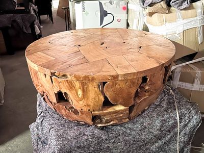 a wooden table that is sitting on top of a pile of boxes