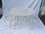 a white table and four chairs sitting on a white sheet