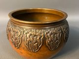 a gold bowl with a design on it