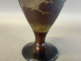 a vase that has a brown base and a white base