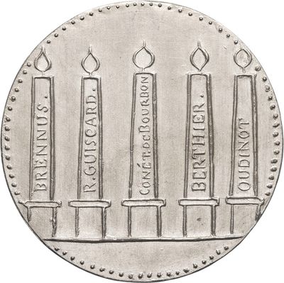 a close up of a silver coin with candles on it