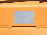 a close up of a piece of blue paper on an orange piece of metal