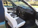 a car that is sitting in the grass with its door open